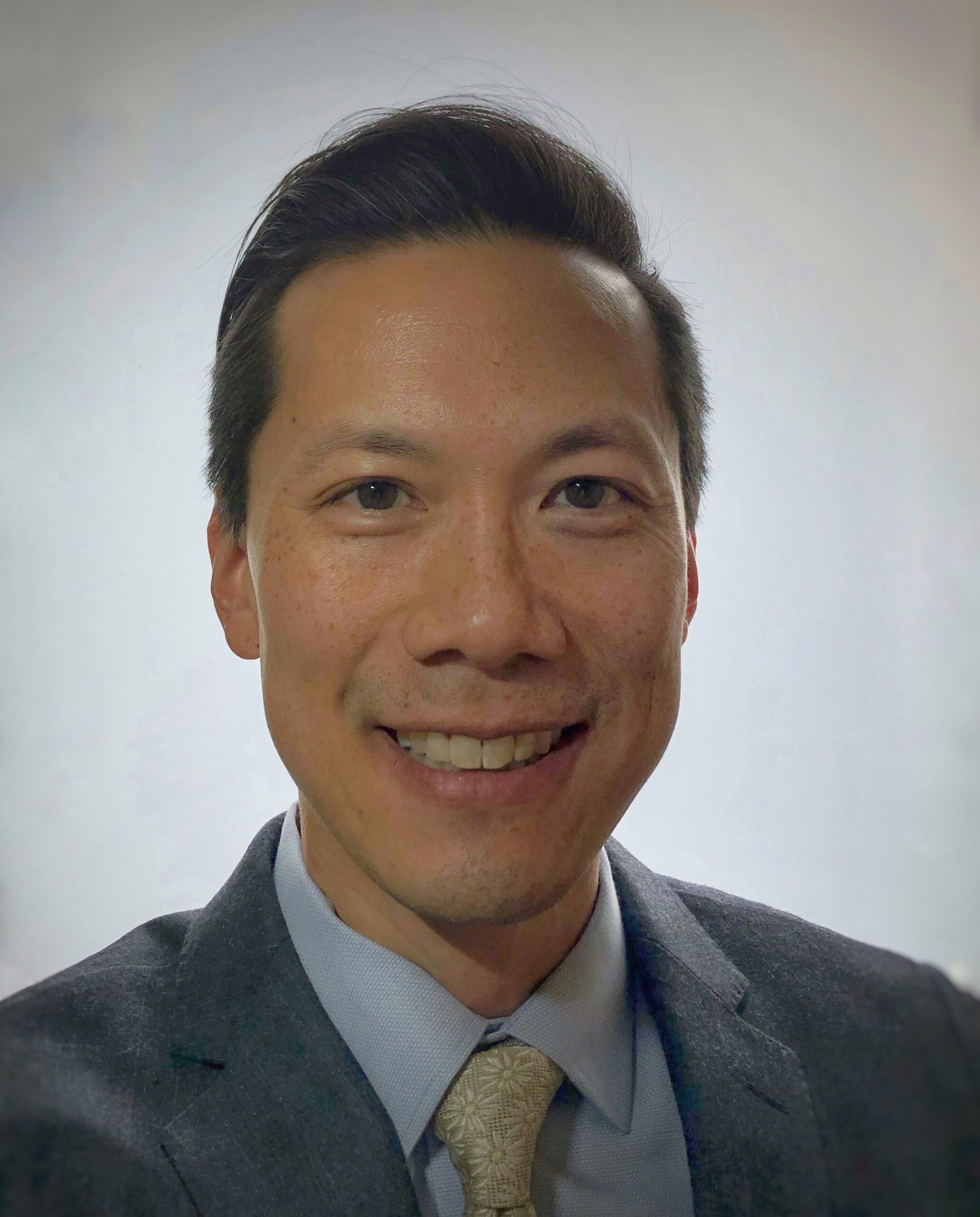 man in suit smiling at camera, Minnesota mental health clinics, ccbhc Minnesota