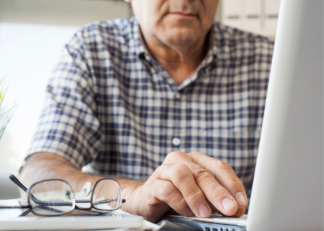 man on typing on computer - therapy telehealth