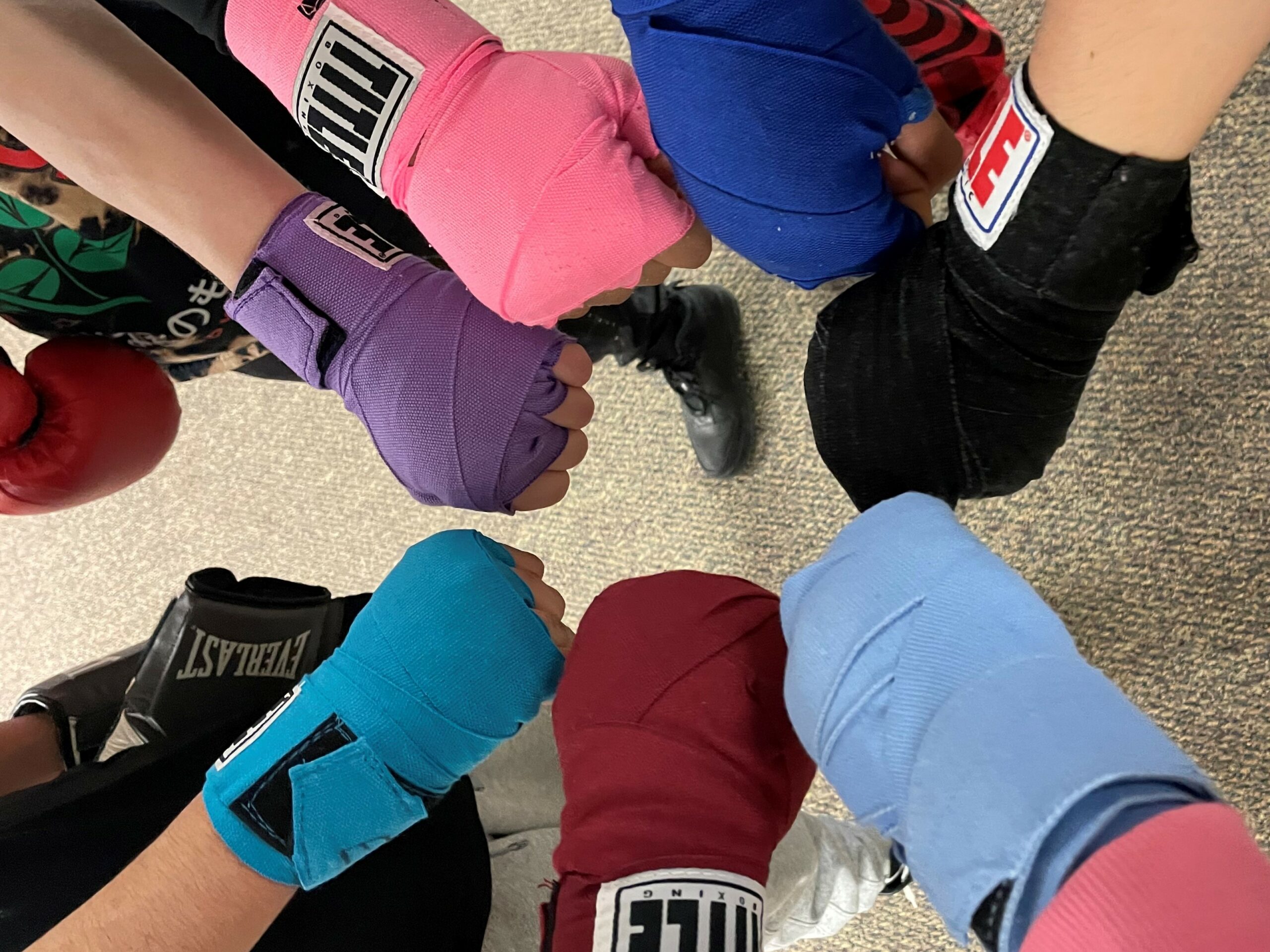 Hands with boxing wraps in circle, Minnesota mental health clinics, ccbhc Minnesota