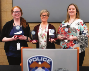 Columbia Heights social workers Eileen Crosby (left) and Erin Buller (right) and their supervisor Jessica Torrey (center) receive the department’s T. Nightingale Community Service Award